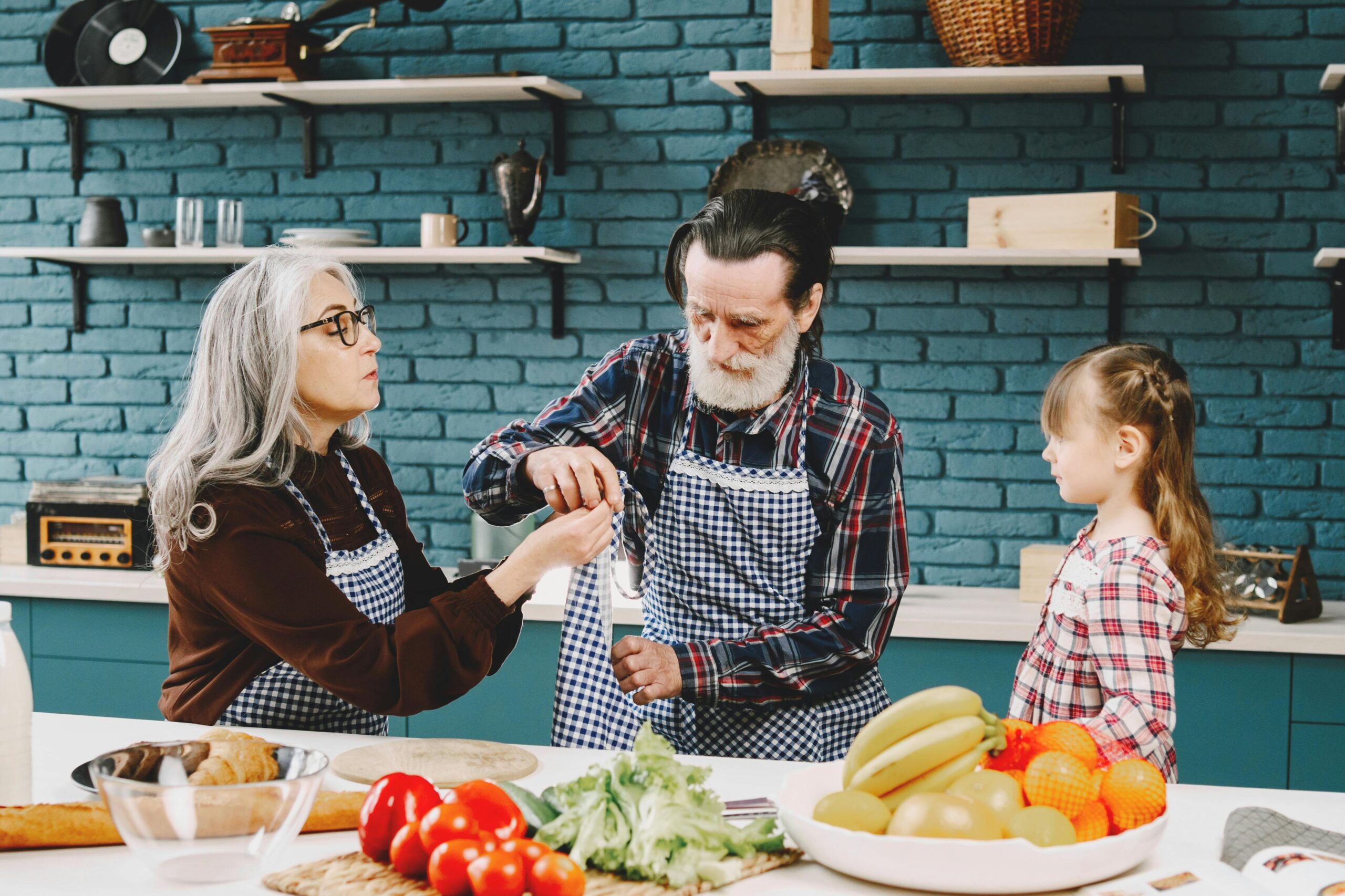 Grandparents preparing food together with their grandchild