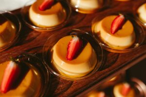 close up of pudding with caramel and strawberries