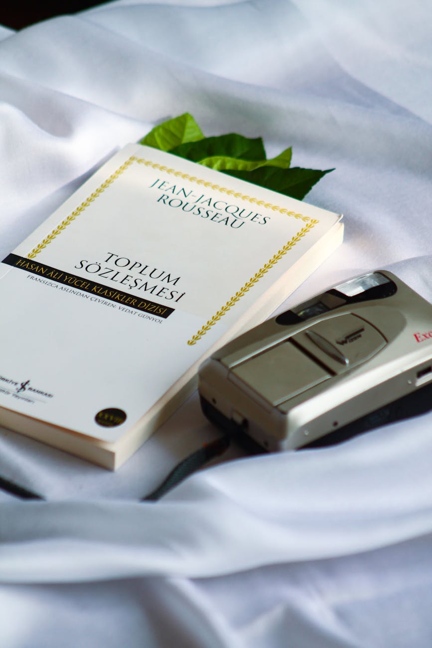book and retro camera on white sheet